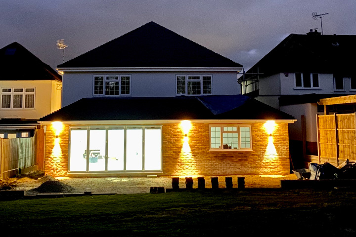 Pic showing a Kentstruction extension shown at night with wall lighting
